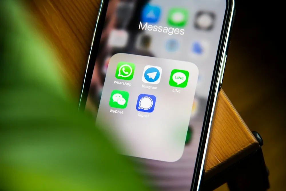 Smartphone showing messaging apps including WhatsApp